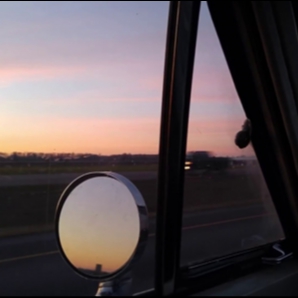 80s cruising down the highway at sunset
